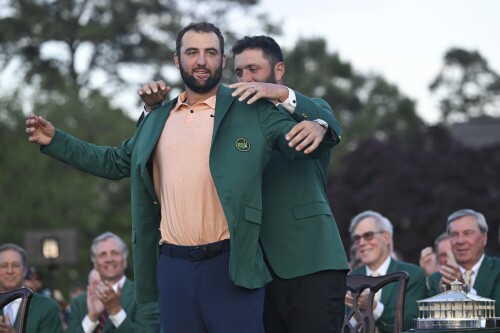 AUGUSTA, GEORGIA - APRIL 14: The 2023 Masters Champion Jon Rahm of Spain, puts on the green jacket of the 2024 Champion, Scottie Scheffler, after the final round of  Masters Tournament at Augusta National Golf Club on April 14, 2024 in Augusta, Georgia. (Photo by Ben Jared/PGA TOUR via Getty Images)