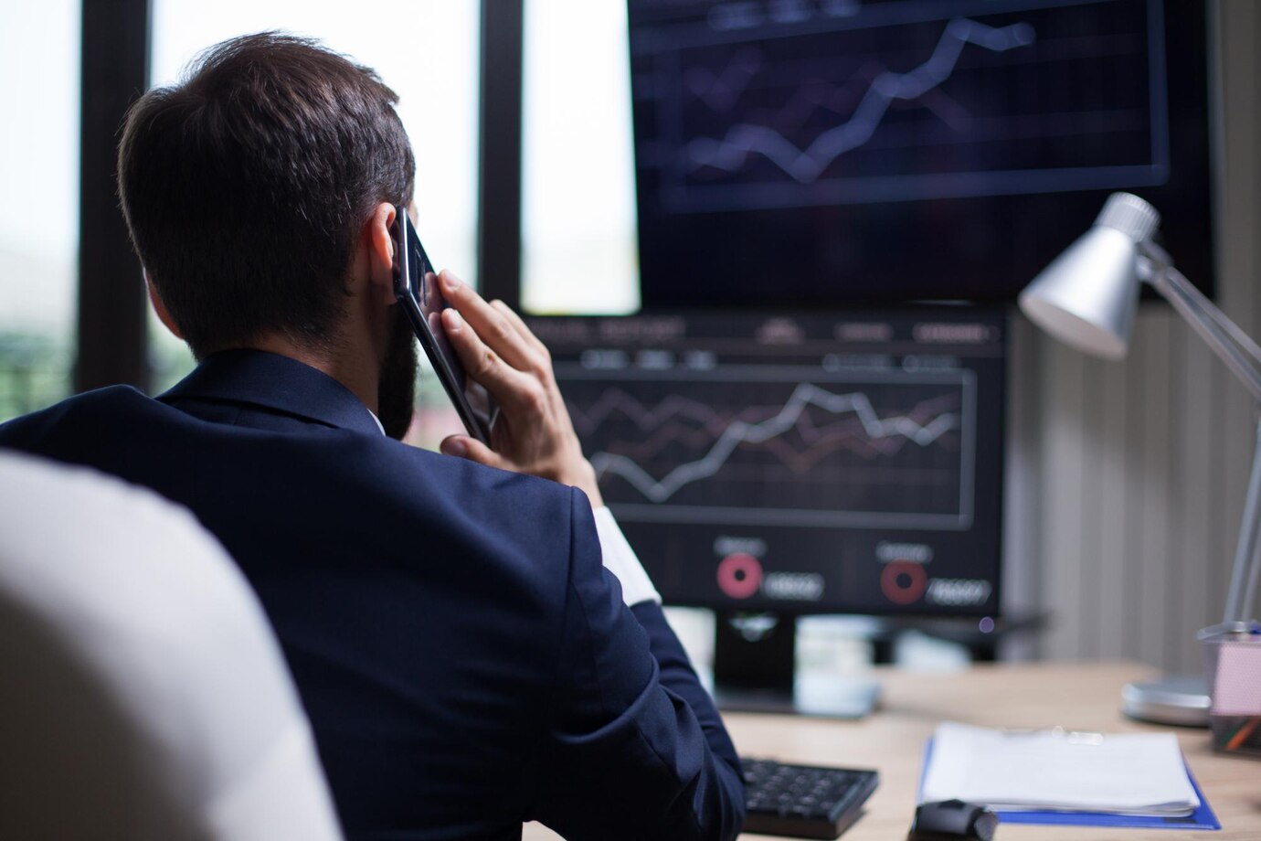 back view young business bearded man having phone call with his ceo diagrams computer monitor 482257" border="0